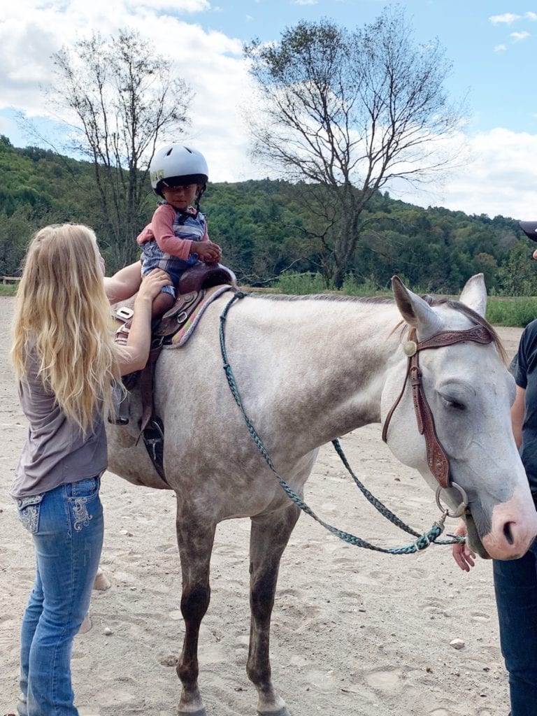 Claire sitting on a horse named Caffine