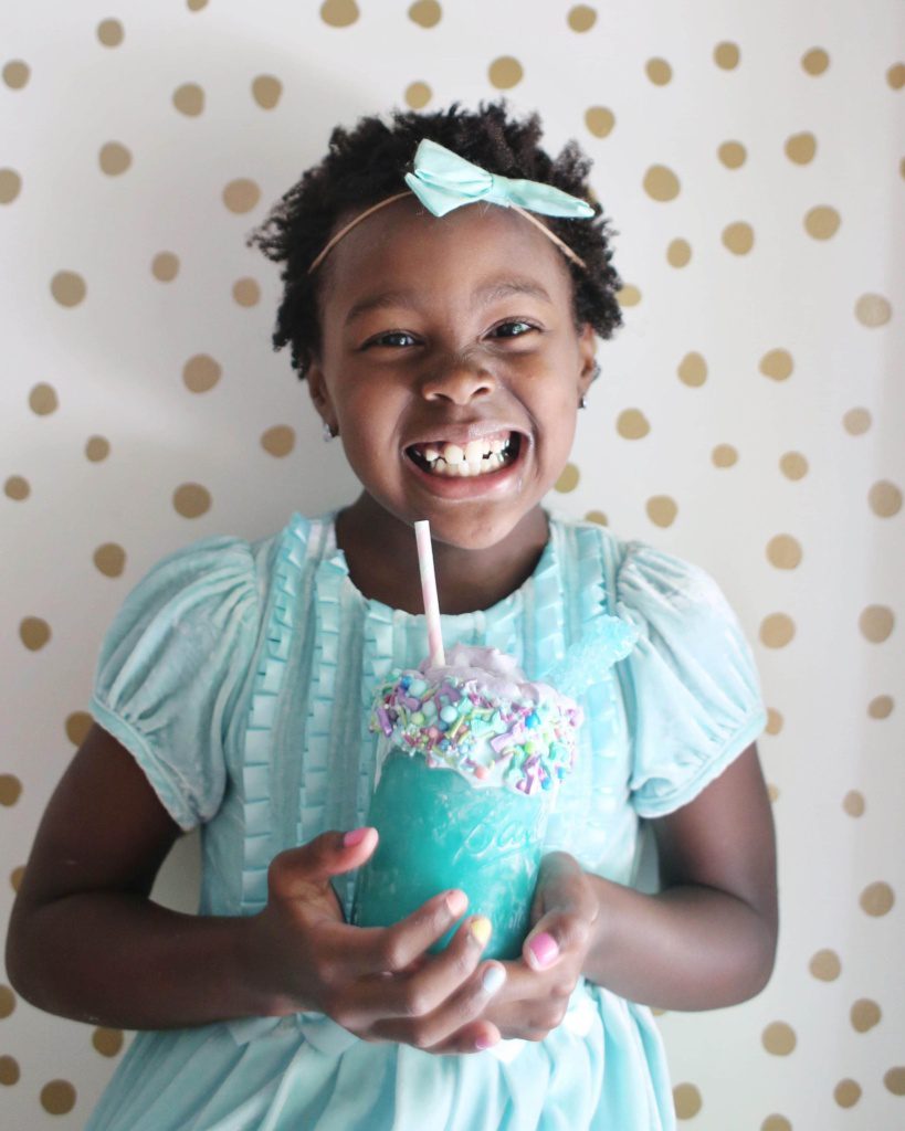 Libby loving her blue mermaid milkshake with purple whipped topping